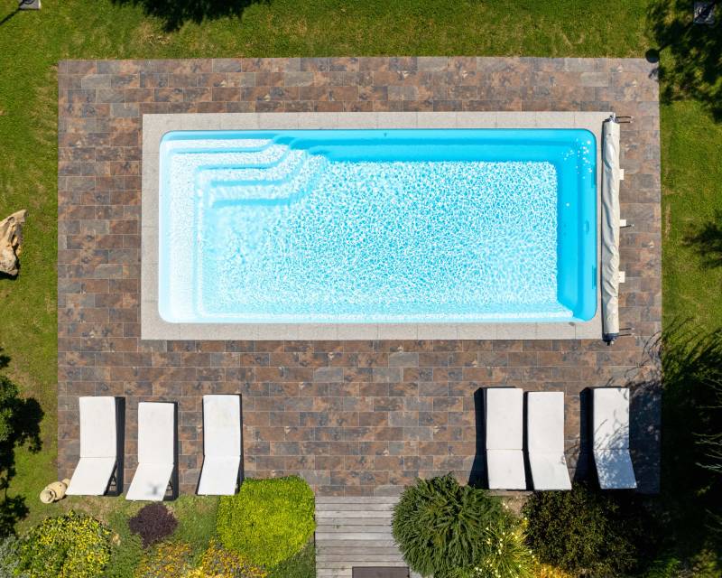 PISCINE COQUE POLYESTER RECTANGULAIRE AVEC ESCALIER D'ANGLE ET BANQUETTE MODÈLE BERMUDES